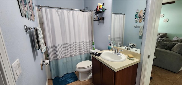 bathroom with toilet, vanity, tile patterned floors, and curtained shower