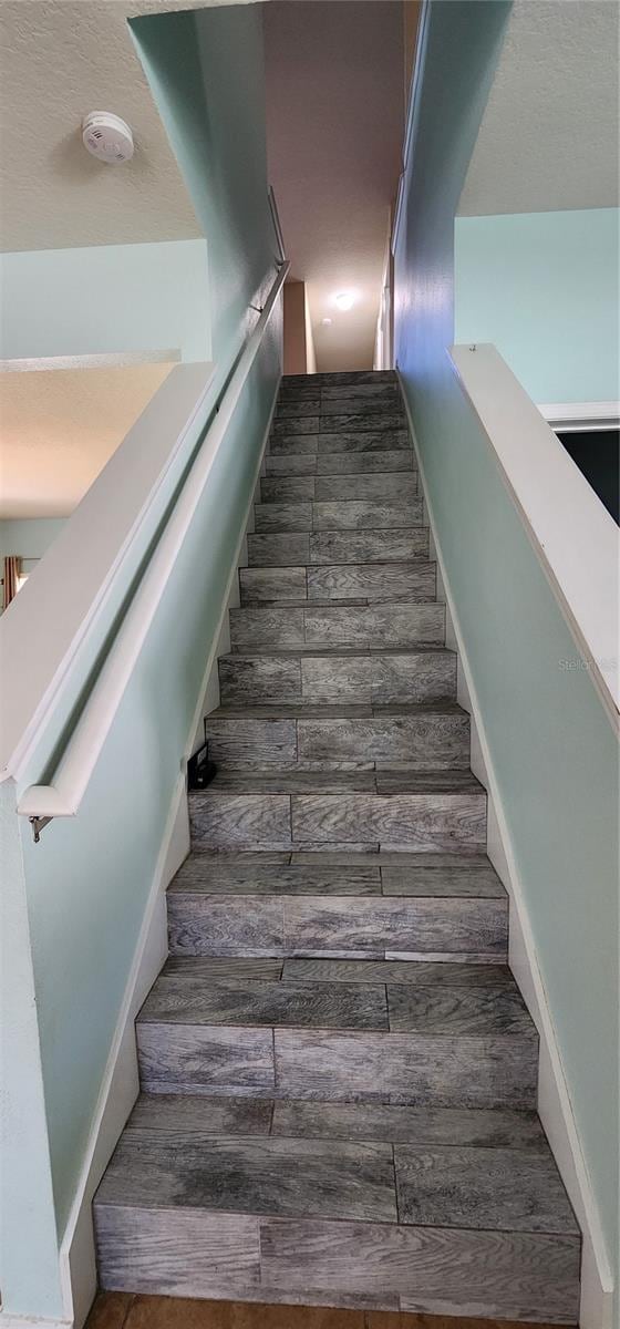 stairs featuring hardwood / wood-style flooring