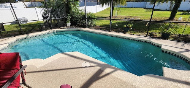 view of pool with a lawn and glass enclosure