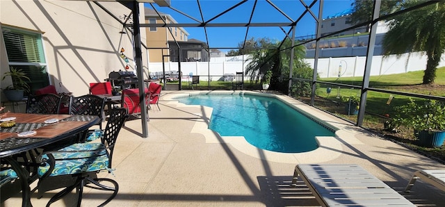 view of swimming pool with area for grilling, glass enclosure, and a patio area