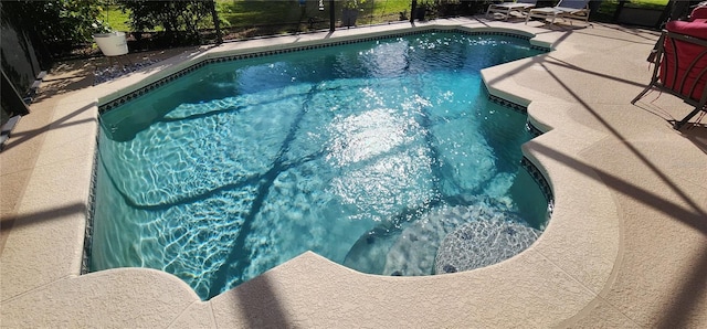 view of swimming pool featuring a lanai and a patio