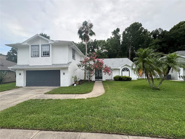 view of front of home with a garage and a front lawn