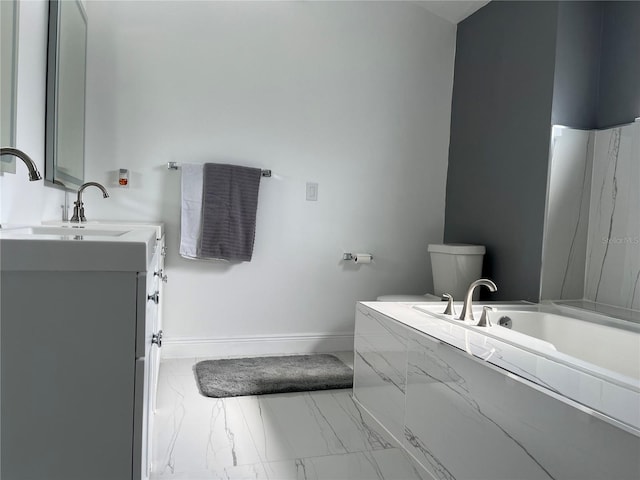 bathroom featuring vanity, a bathtub, and toilet