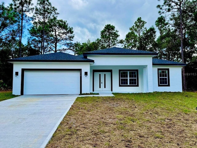 view of front of property featuring a front lawn, a garage, and french doors