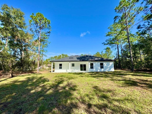 back of house with a lawn