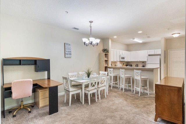 carpeted dining area with an inviting chandelier