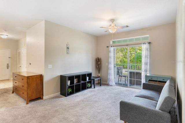 interior space featuring ceiling fan and light carpet