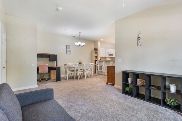 carpeted living room featuring a notable chandelier