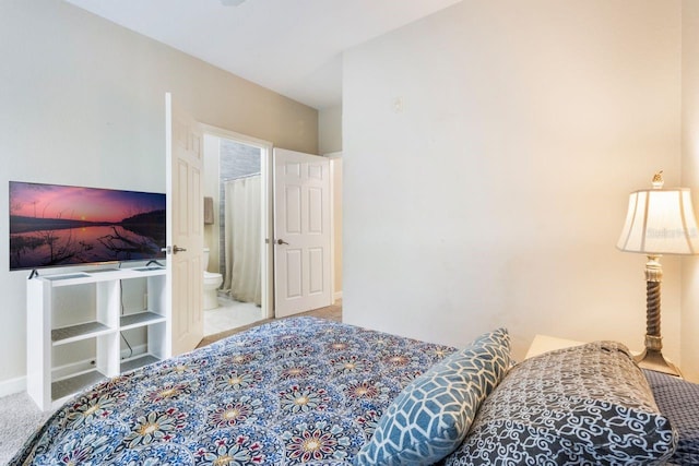 carpeted bedroom featuring connected bathroom