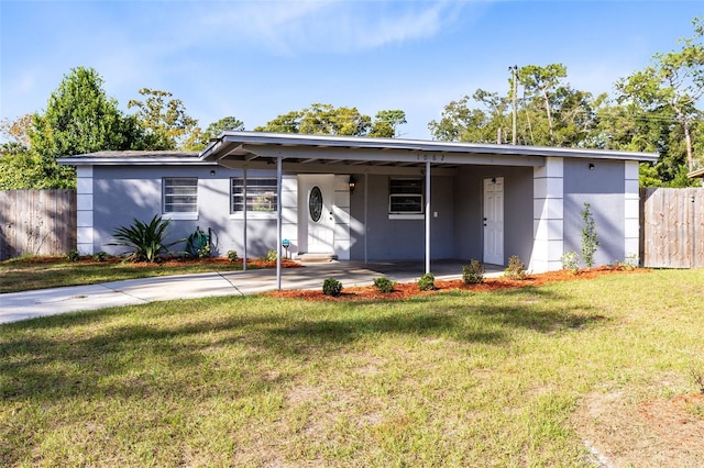 ranch-style house with a front yard and a carport