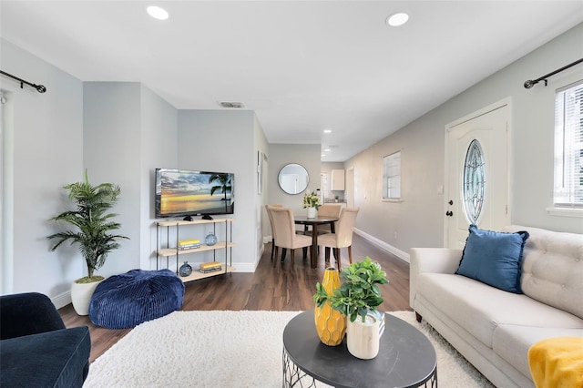 living area featuring dark wood finished floors, visible vents, recessed lighting, and baseboards