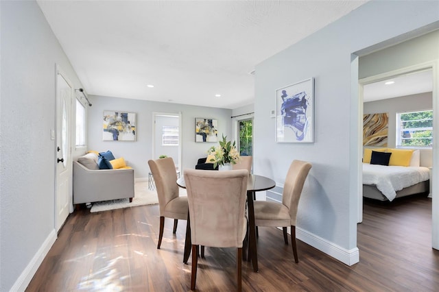 dining area featuring recessed lighting, dark wood-type flooring, and baseboards