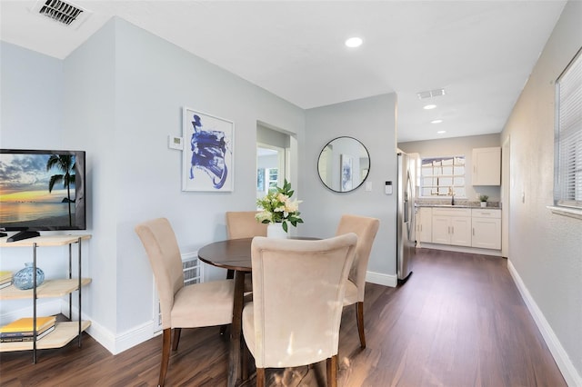 dining space featuring visible vents, baseboards, and dark wood-style floors