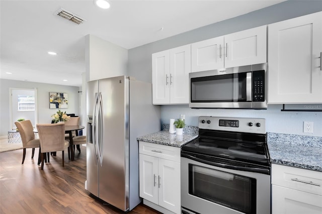 kitchen with visible vents, appliances with stainless steel finishes, and white cabinets