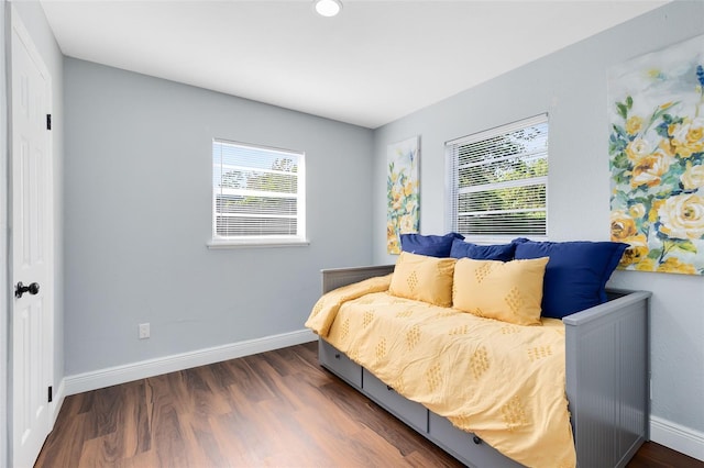 bedroom with baseboards and dark wood-style floors