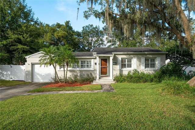 ranch-style house featuring a front yard and a garage