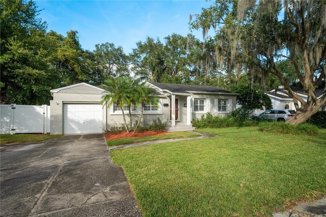 ranch-style home with a garage and a front lawn