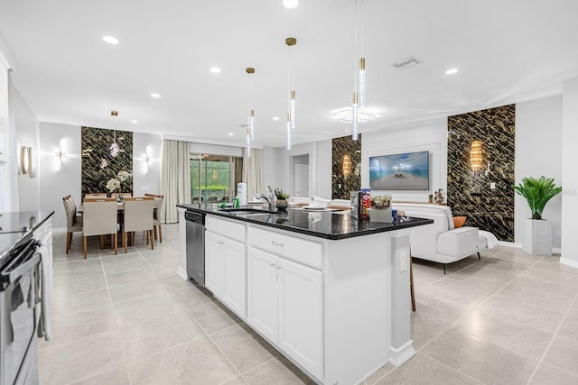 kitchen with stainless steel dishwasher, range, white cabinetry, hanging light fixtures, and an island with sink