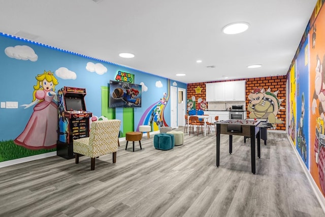 recreation room with light hardwood / wood-style flooring