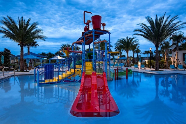 view of swimming pool with a playground