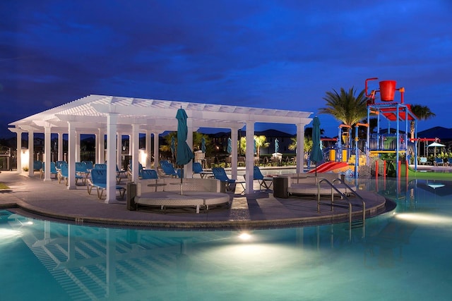 view of swimming pool with a playground and a pergola