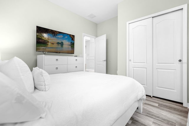 bedroom featuring light wood-type flooring and a closet