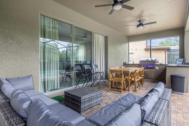 view of patio featuring outdoor lounge area, ceiling fan, area for grilling, and grilling area