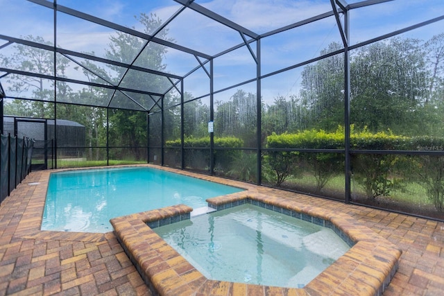 view of pool with a patio area, a lanai, and an in ground hot tub