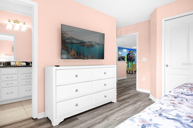 bedroom featuring hardwood / wood-style floors and sink