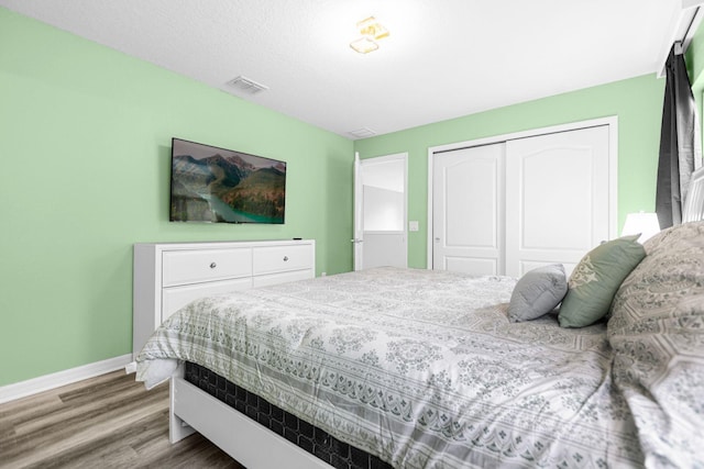 bedroom featuring hardwood / wood-style flooring and a closet