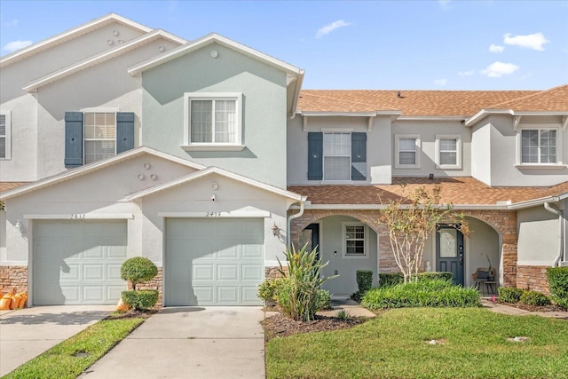 view of front of property with a front yard and a garage