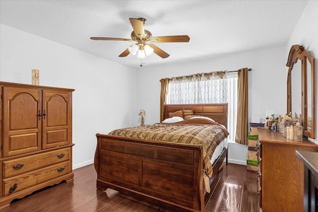 bedroom with ceiling fan and dark wood-type flooring