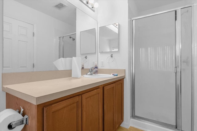 bathroom featuring vanity and a shower with shower door