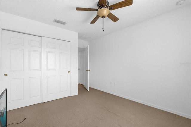 unfurnished bedroom featuring a closet, ceiling fan, and carpet flooring