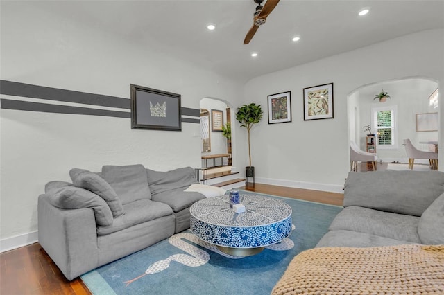 living room with ceiling fan and dark hardwood / wood-style floors