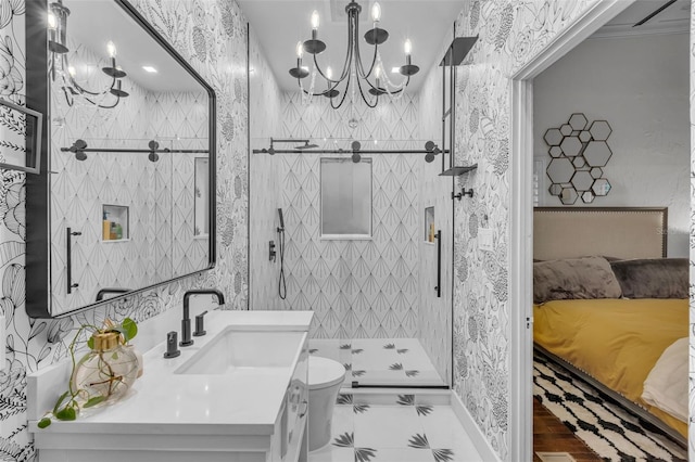 bathroom with toilet, a shower, sink, and a notable chandelier