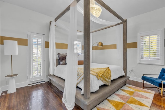 bedroom with hardwood / wood-style flooring and multiple windows