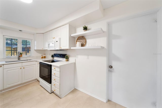 kitchen with white appliances, white cabinets, and sink