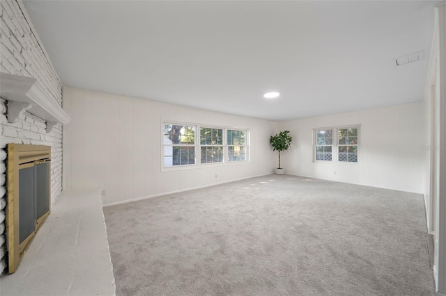 unfurnished living room with a fireplace and carpet floors