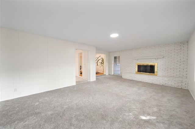 unfurnished living room with a fireplace and carpet floors