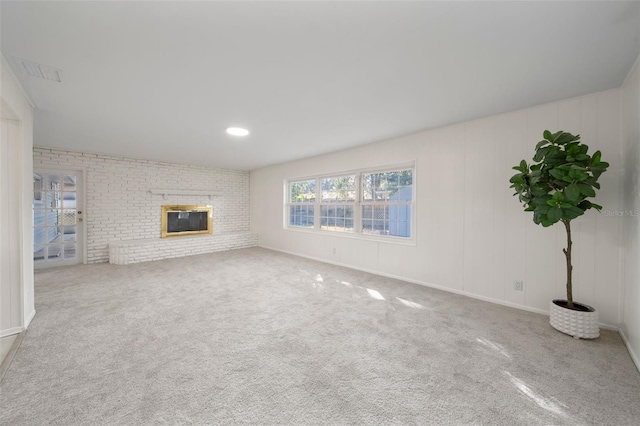 unfurnished living room with a fireplace and carpet flooring