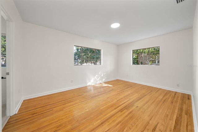 unfurnished room with light wood-type flooring