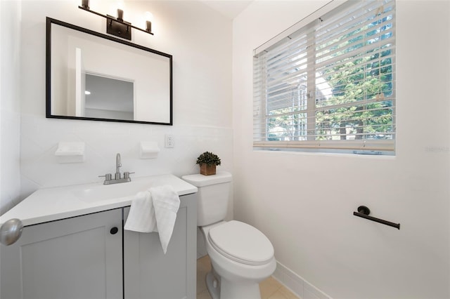 bathroom featuring tile walls, vanity, and toilet