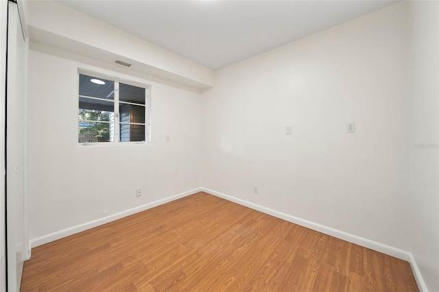 unfurnished room with hardwood / wood-style flooring