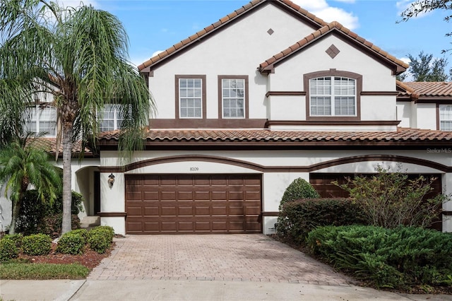 mediterranean / spanish house with a garage