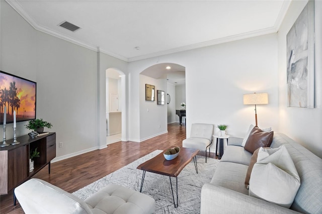 living room featuring hardwood / wood-style flooring and crown molding