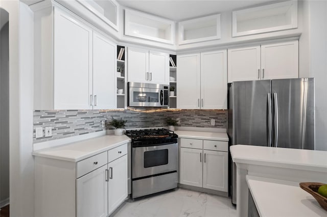 kitchen featuring backsplash, white cabinets, and appliances with stainless steel finishes