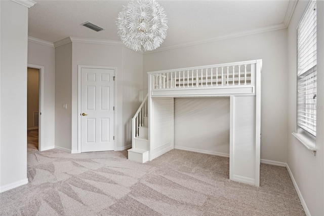 unfurnished bedroom featuring light colored carpet, a closet, and ornamental molding