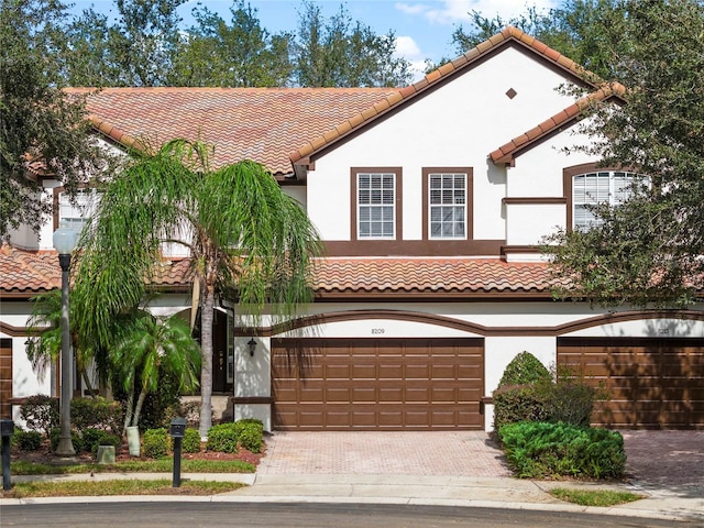 mediterranean / spanish home with a garage