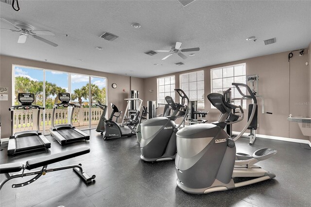 gym with a textured ceiling and ceiling fan